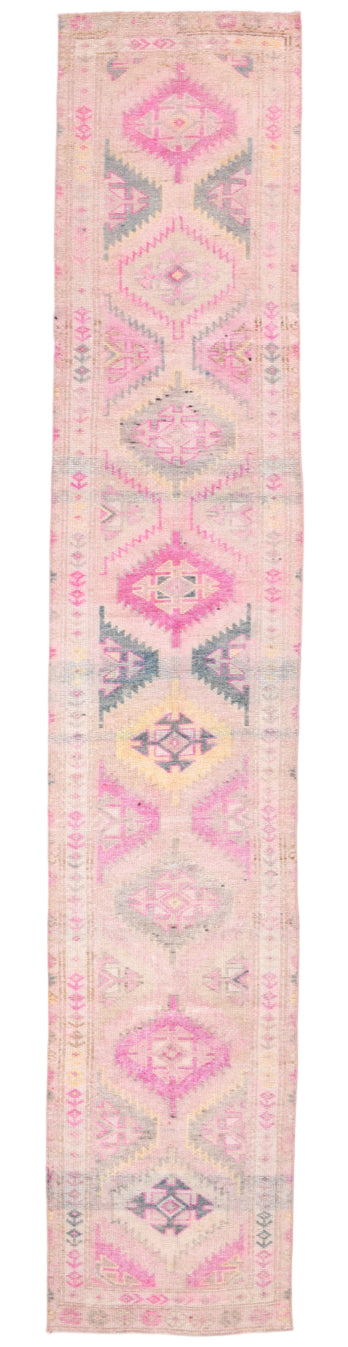 Pink and beige patterned rug with geometric design