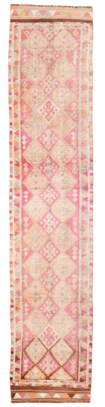 Pink and beige patterned rug with geometric designs