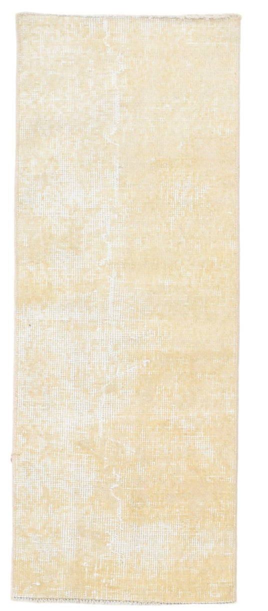 Beige area rug with a textured pattern on a white background