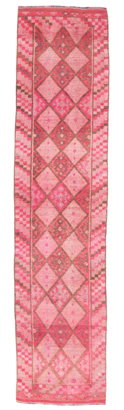 Long pink woven textile with geometric patterns