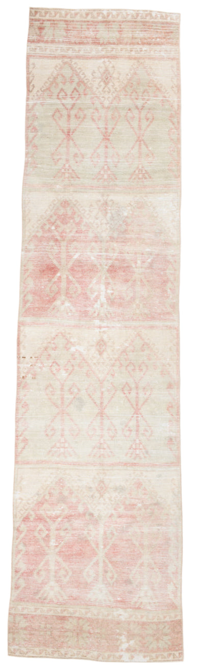 Long narrow rug with a subtle pattern on a plain background
