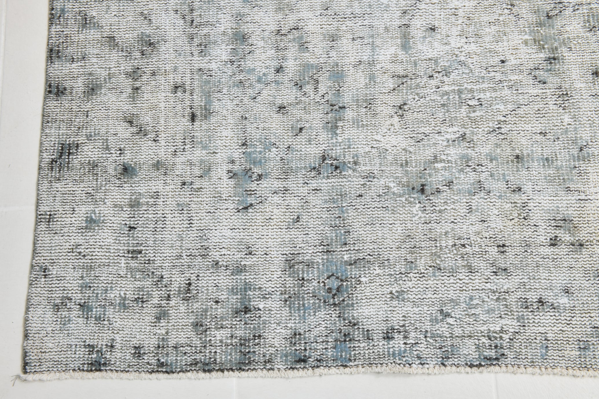 Textured gray and black fabric swatch on a white background