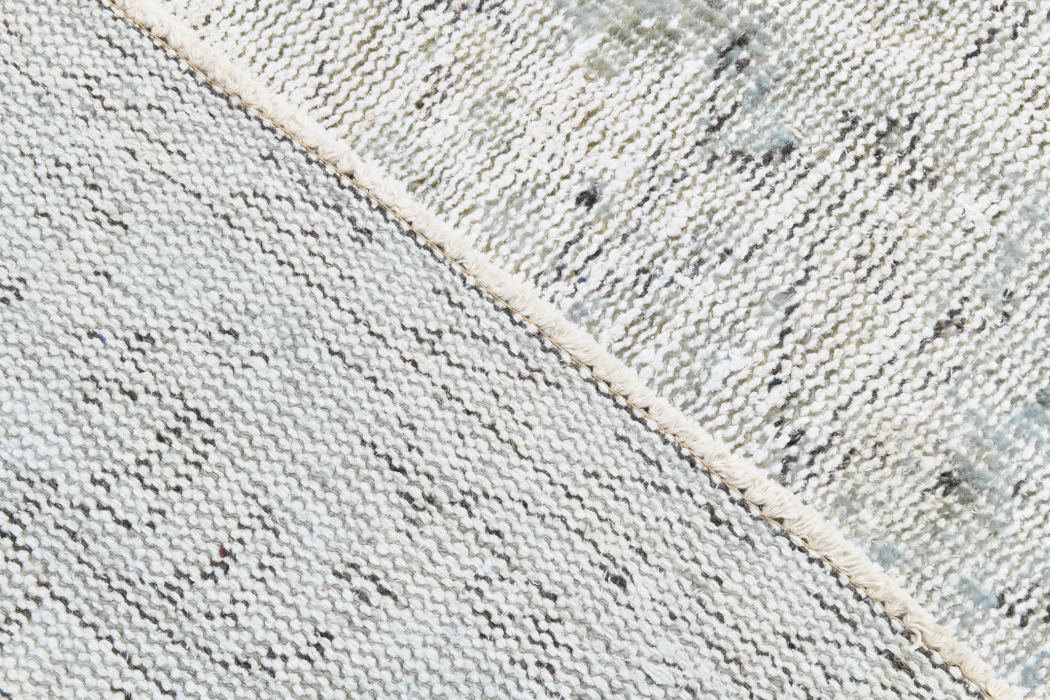 Close-up of a textured fabric with a diagonal stripe pattern.