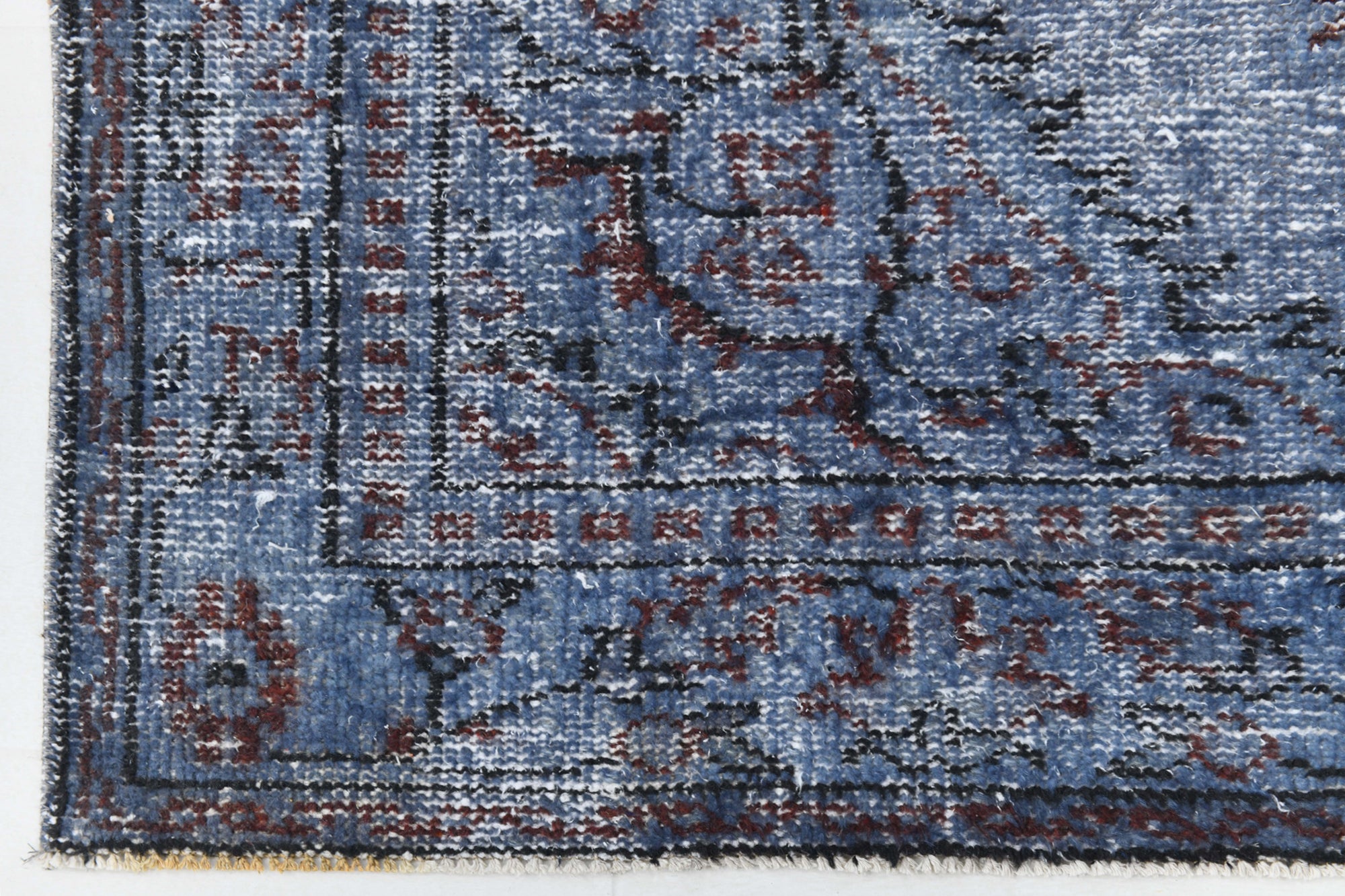 Close-up of a blue patterned rug with intricate designs
